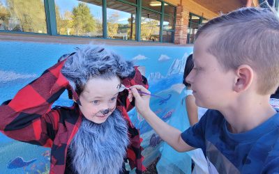Tyler painting Colton’s face at the school Halloween party